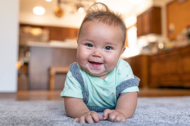 Baby lying on carpet flooring | Frazee Carpet & Flooring